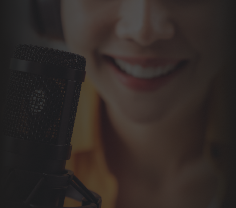 A close-up of a person recording their speech into a microphone for accent reduction analysis, focusing on the microphone and the lower half of their face with a warm smile, symbolizing confidence and engagement in the process.